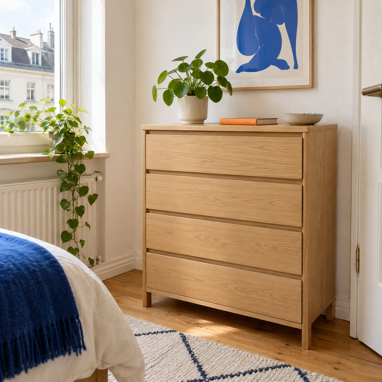 A wooden dresser with a plant in a bright student room